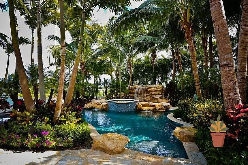 19 Backyard Patio Designs With Pool Makeovers That Look Incredibly Expensive 12 Tropical Poolscape with Layered Greenery